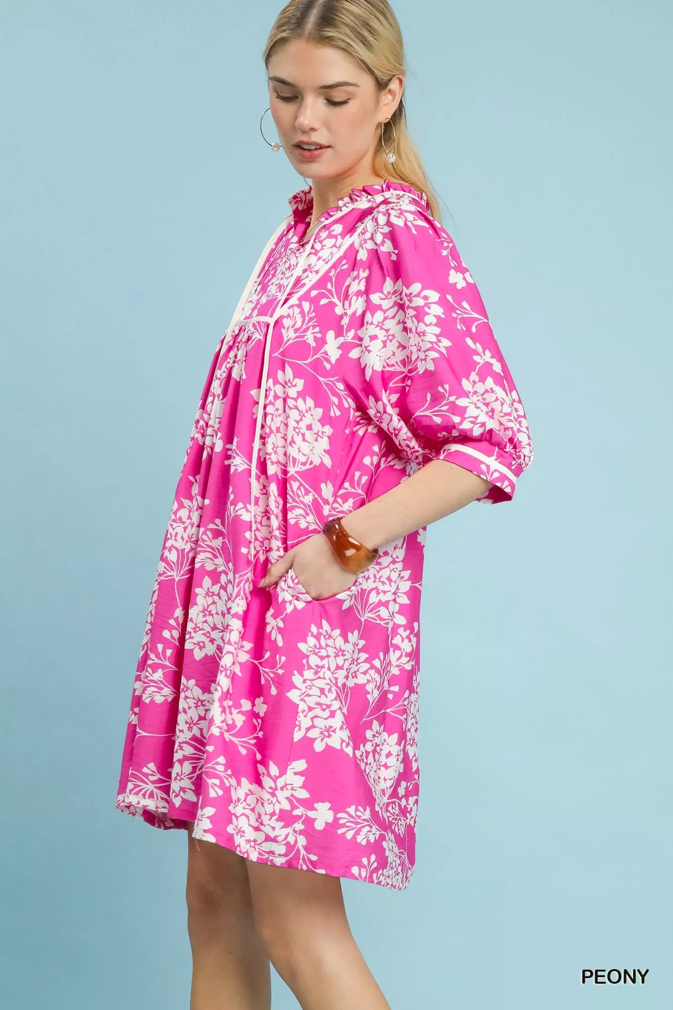 Side view of Umgee floral babydoll dress with pockets showing relaxed silhouette and drape

