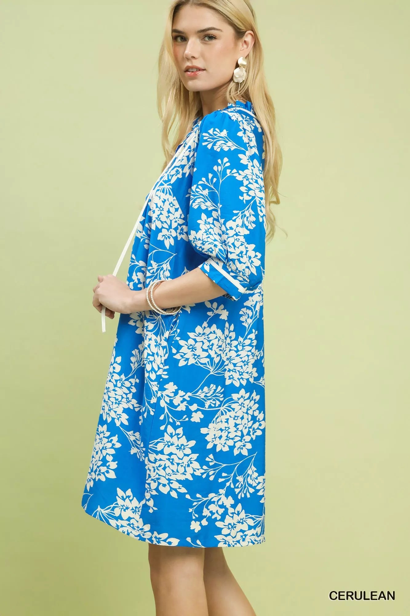 Side view of Umgee floral babydoll dress with pockets showing flowy silhouette
