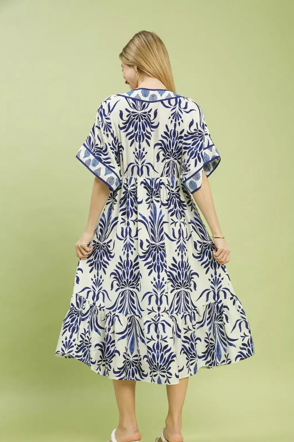 Umgee floral border print midi dress with pockets for women model standing facing back, back view of midi dress with floral border print and convenient pockets
