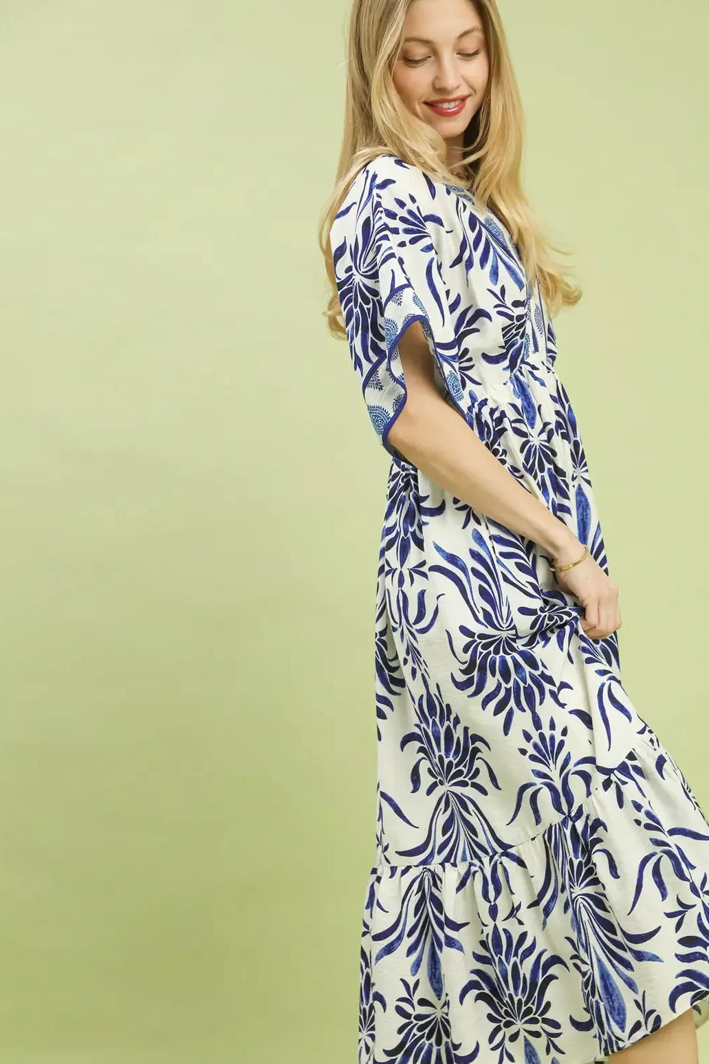 Umgee floral border print midi dress with pockets for women model standing facing side, side view of floral border print midi dress, showing silhouette and pocket access