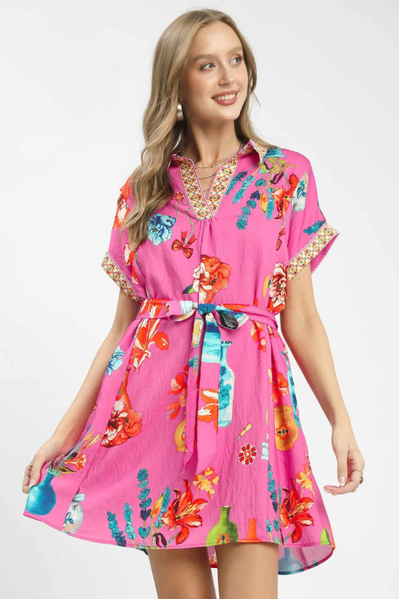 Front view of Umgee floral print mini dress with belt showing flirty silhouette and feminine boutique style.