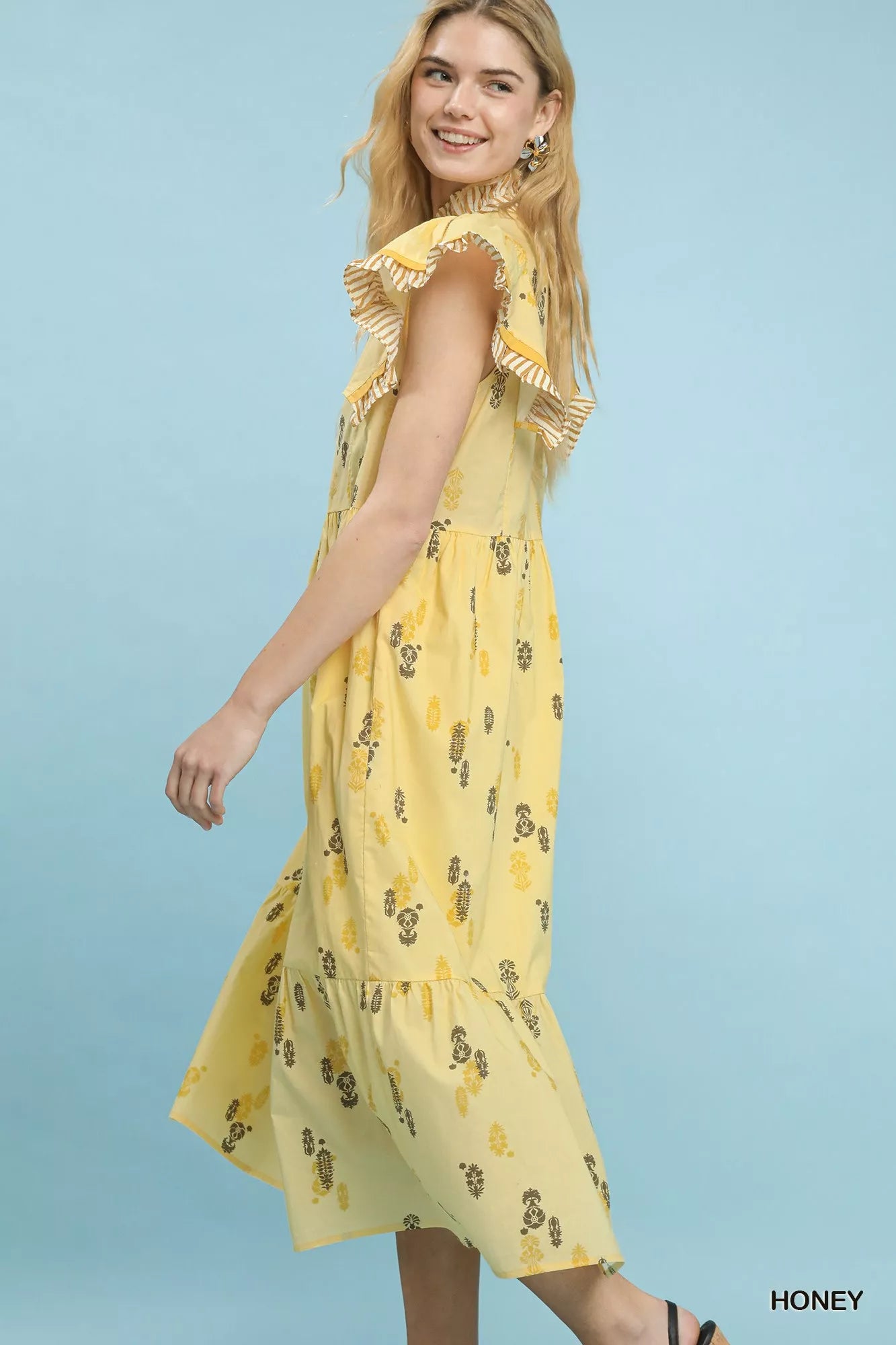 Side view of Umgee floral ruffle sleeve tiered midi dress highlighting tiered skirt
