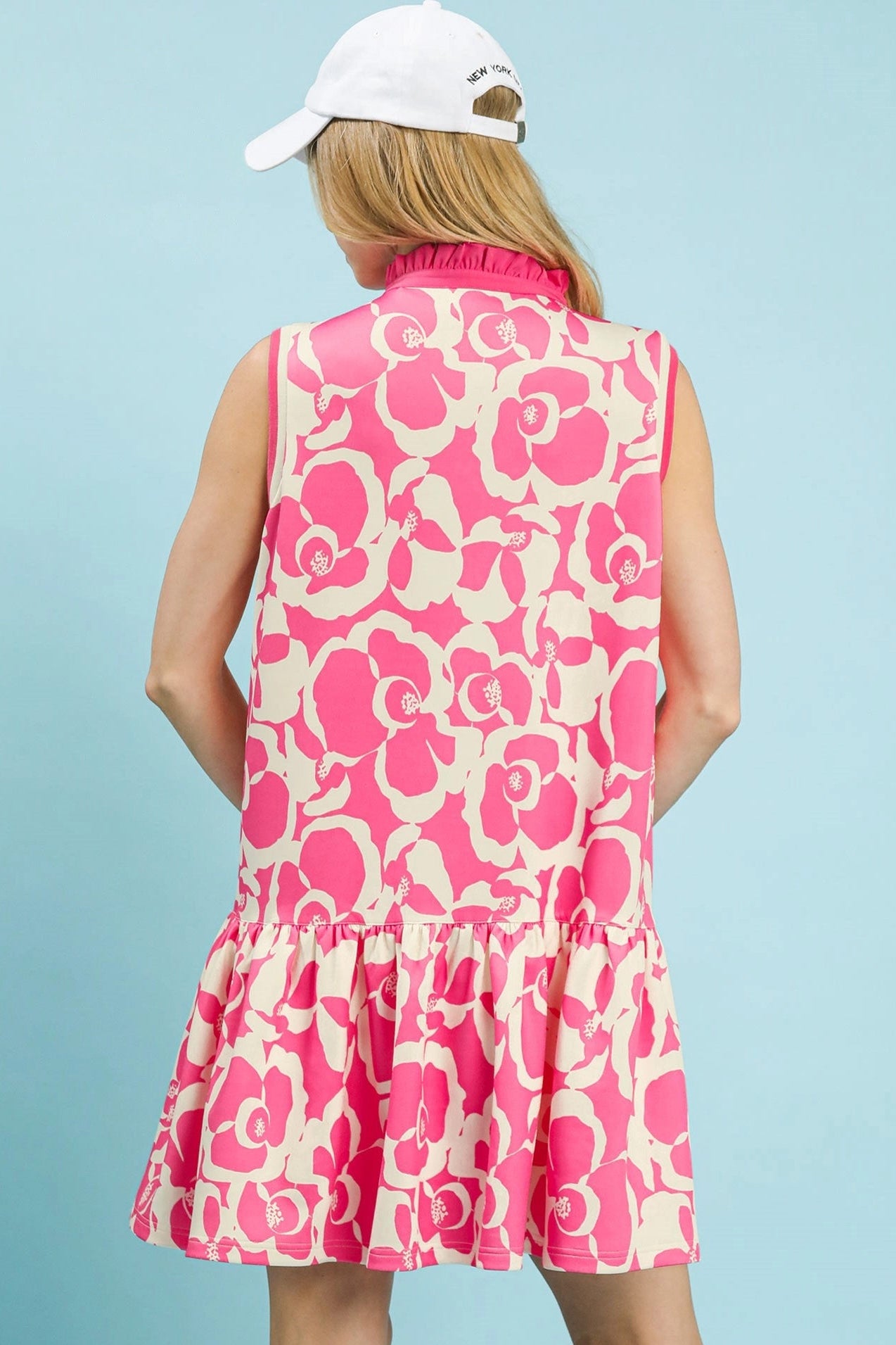 Back view of Umgee floral sleeveless tiered dress with flowy silhouette and ruffle hem, feminine women’s mini dress style