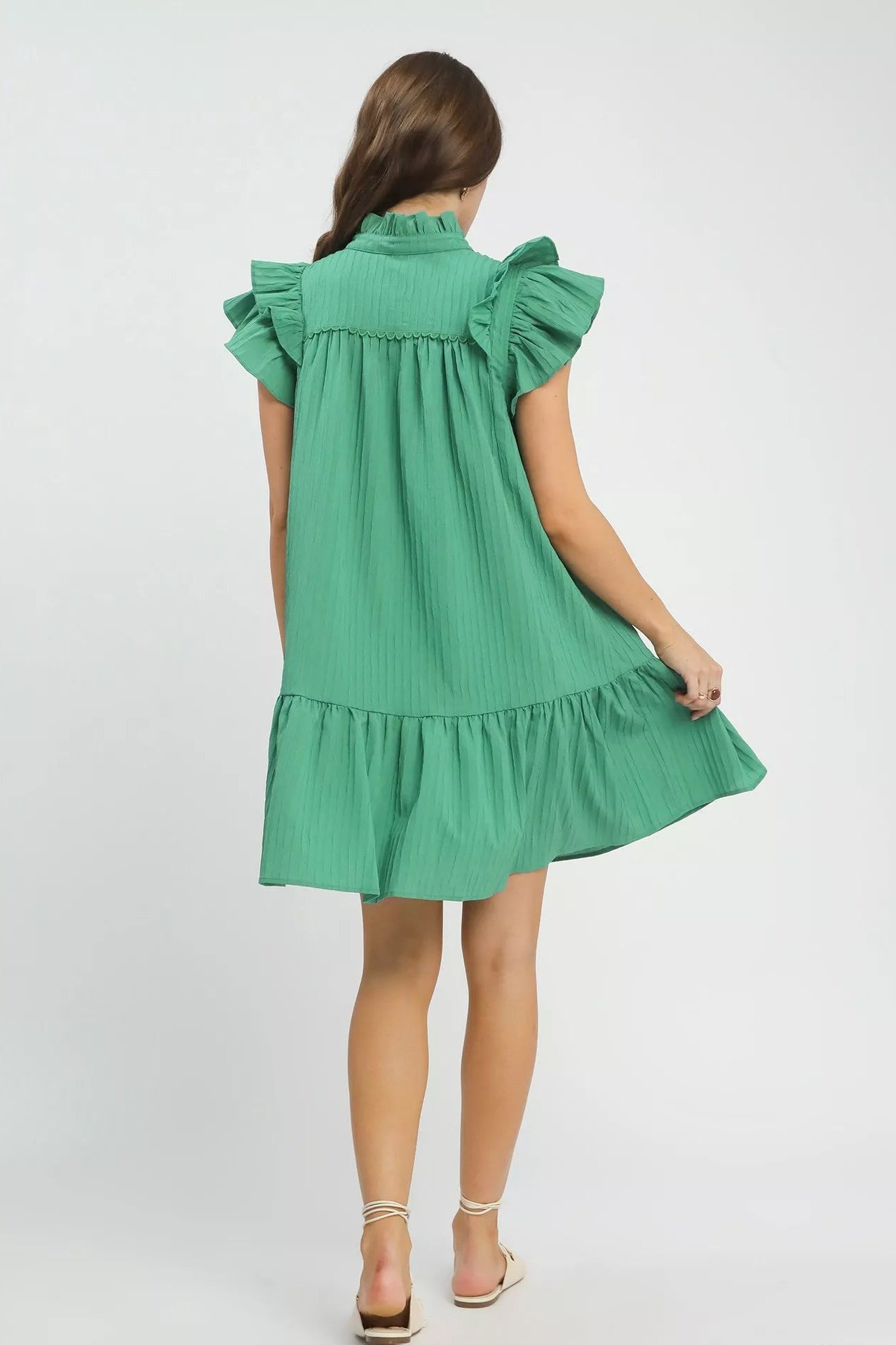 Back view of Umgee flutter sleeve tiered dress showing layered tiers, flowy fit, and boutique feminine style.