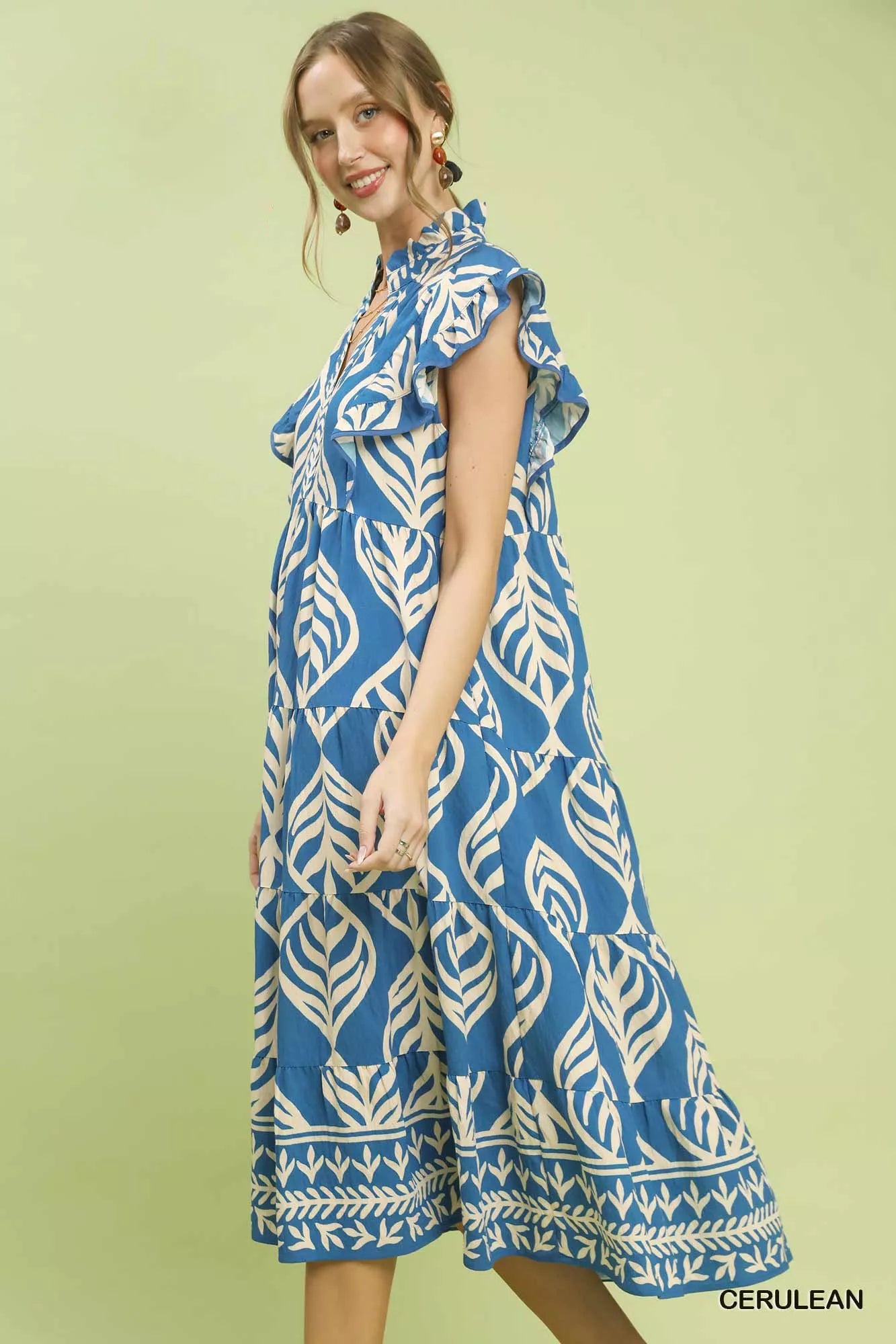 Side view of Umgee Leaf Print Tiered Midi Dress with Pockets highlighting pocket detail and movement of tiered fabric.