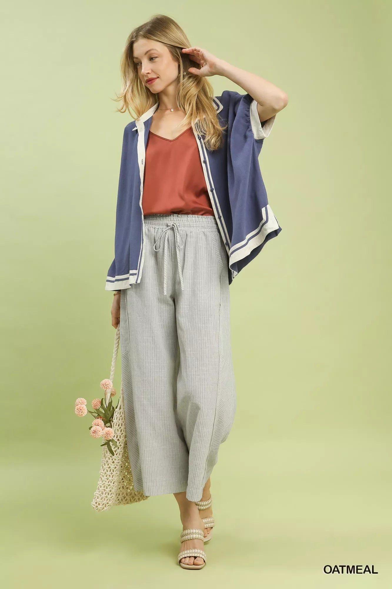 Model wearing Umgee linen blend striped wide leg pants, front angle showing flowy fit.
