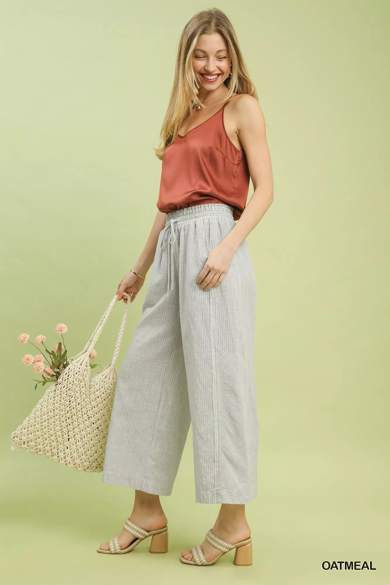 Side view of Umgee linen blend striped wide leg pants highlighting wide silhouette.

