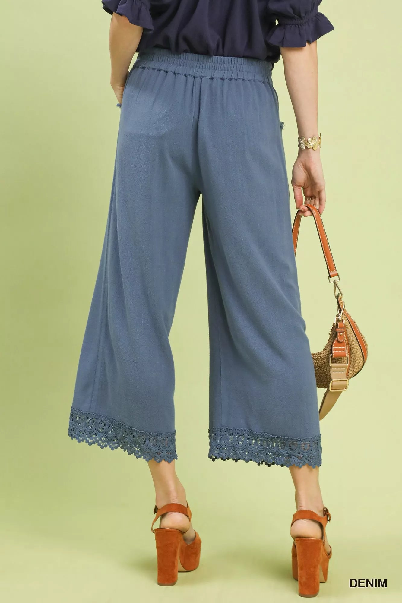 Back view of Umgee linen wide leg cropped pants with lace trim on model

