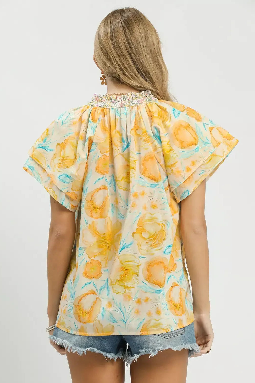 Umgee Mixed Floral Blouse with Crochet Lace Trim back view - rear view of floral boho top with lace trim accents, flutter sleeve flow, and relaxed upper back coverage

