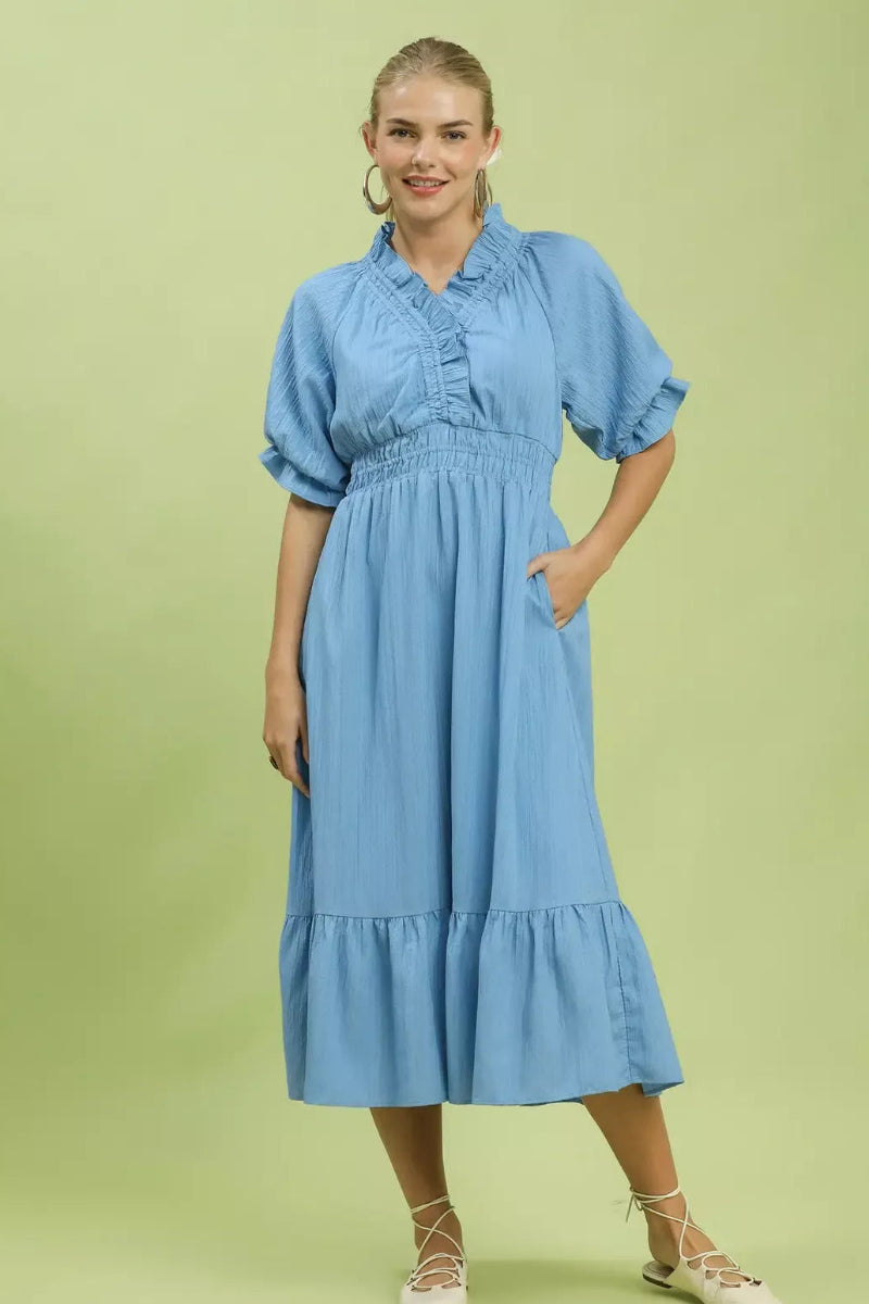 Umgee ruffle V-neck midi dress for women model standing facing front, showing ruffle detailing, V-neckline, midi length, flowy silhouette