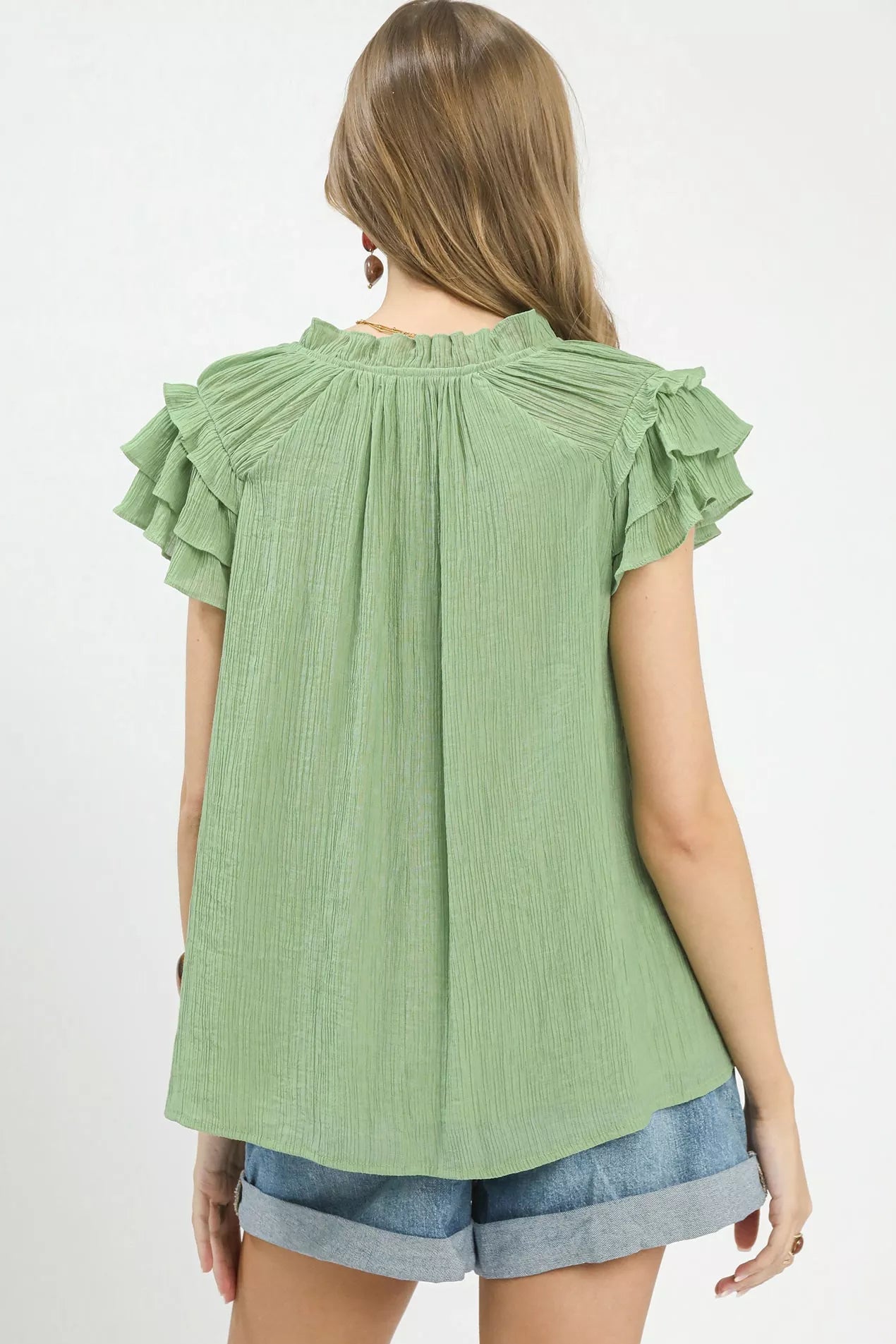 Back view of Umgee ruffled flutter sleeve blouse showing textured fabric and relaxed fit, elegant women’s romantic style top