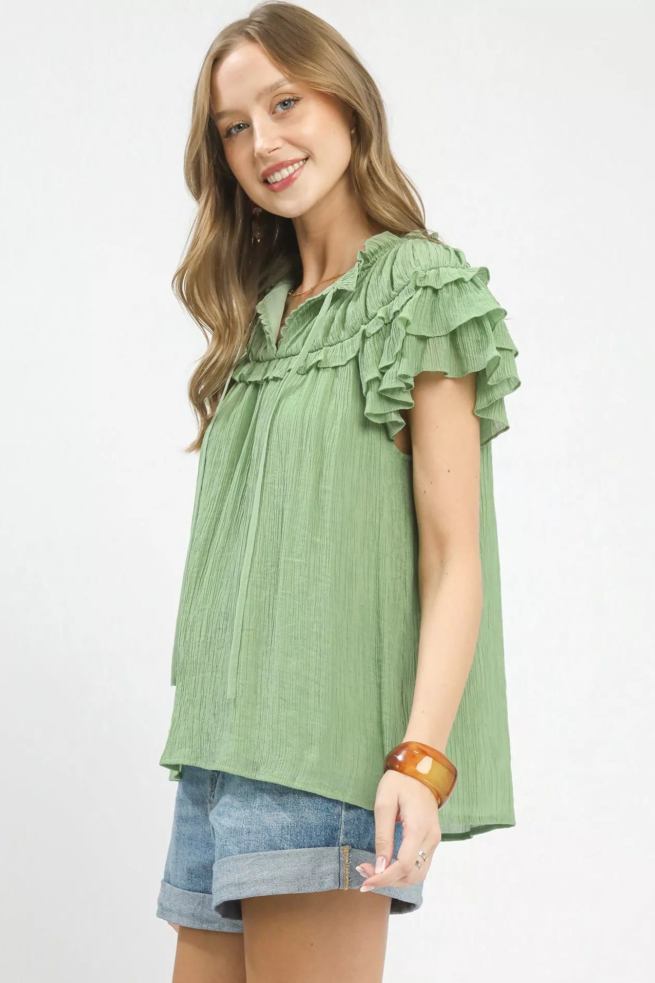 Side view of Umgee ruffled flutter sleeve blouse featuring flutter sleeves and tie detail, lightweight women’s blouse with romantic design