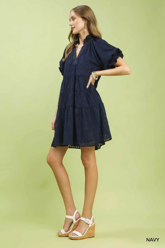 Side view of Umgee textured mini dress highlighting tiered layers and ruffle collar
