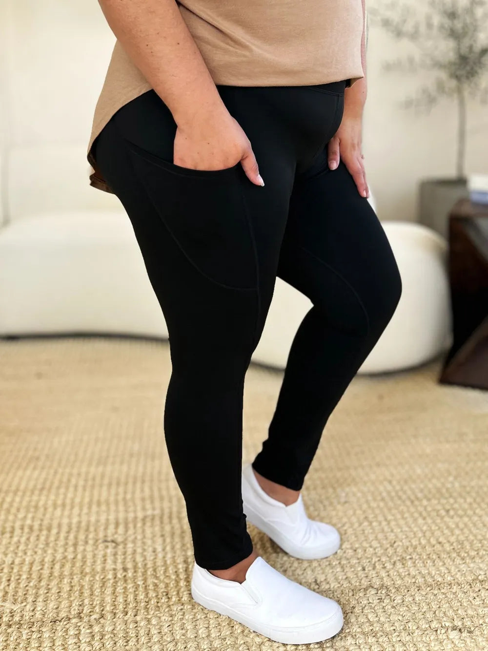 Right side view of athletic leggings with nylon spandex blend, knee bent, fabric stretched but still opaque, tummy control waistband