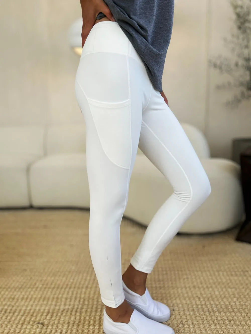 Right side view of athletic leggings with nylon spandex blend, knee bent, fabric stretched but still opaque, tummy control waistband