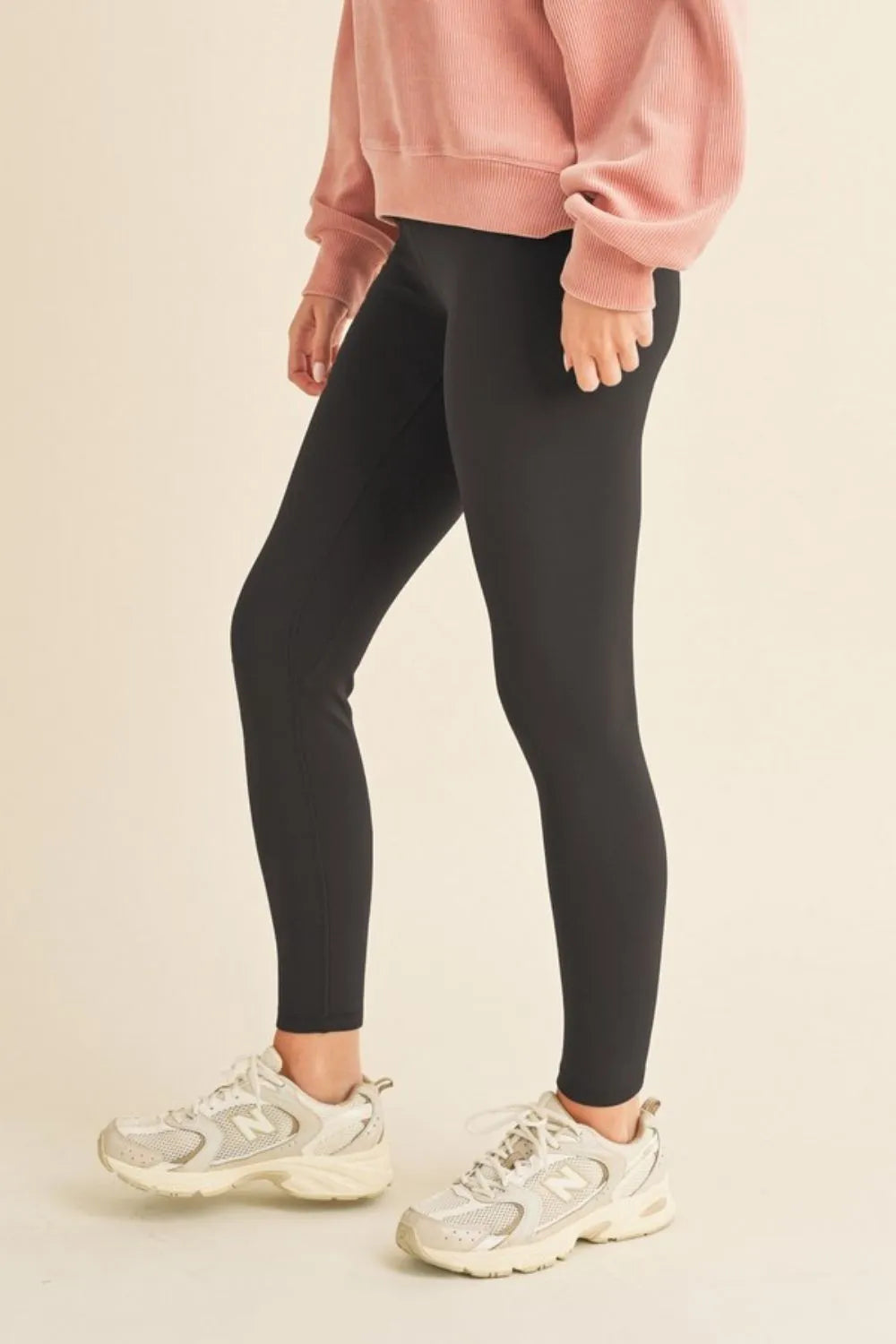 Side profile of Yelete high waisted fleece lined leggings displaying flattering contour and cozy winter thickness.