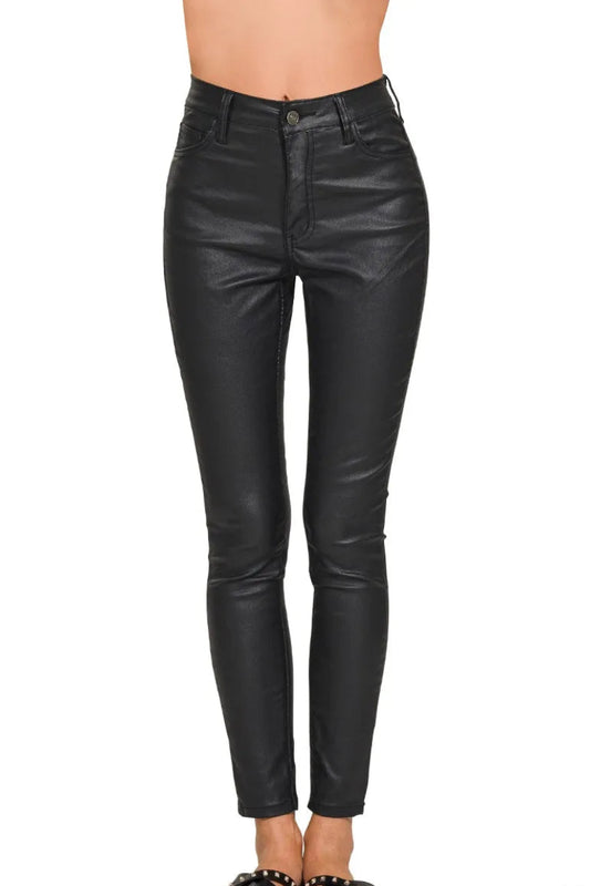 Model standing straight on wearing matte faux leather skinny pants, stretch fit through hip and thigh, front pockets visible, sleek edgy silhouette