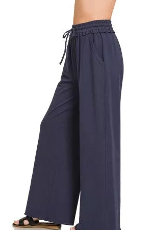 Zenana French Terry wide leg sweatpants for women model standing facing side, side view of wide leg sweatpants with French Terry material, showing drape and comfortable fit
