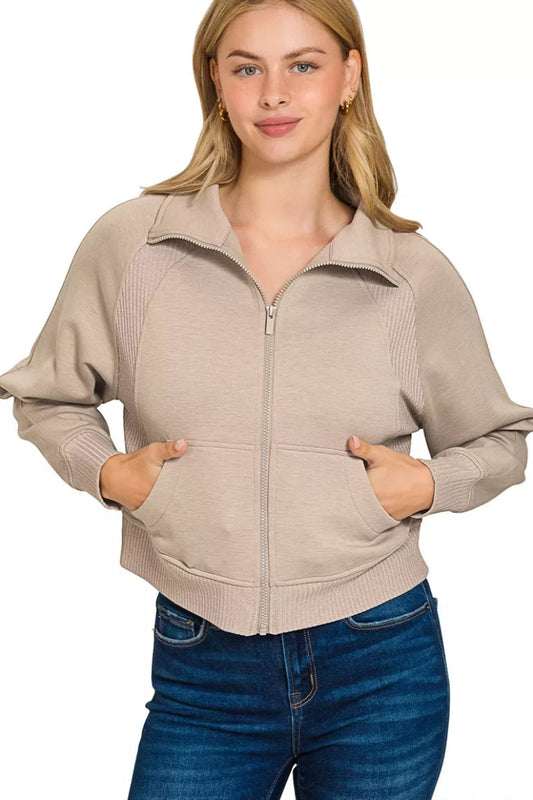 Zenana scuba full zip cropped jacket front view with pockets, hands in pockets, showing full length and ribbed trim on a model.