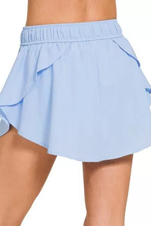 Zenana soft woven active skorts 2-in-1 lightweight model standing facing back, back view of woven skorts with 2-in-1 design for active wear
